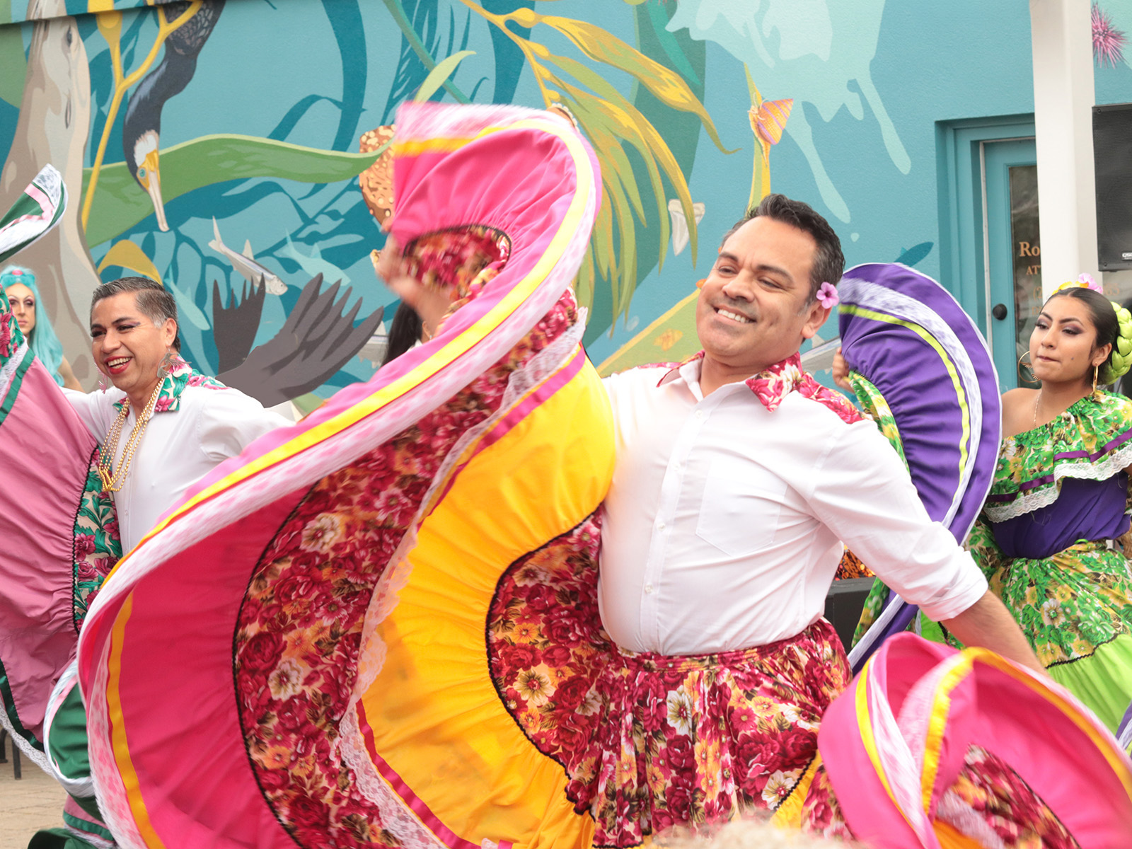 members of the gender inclusive Ensamble Folclórico Colibrí dancing in colorful skirts