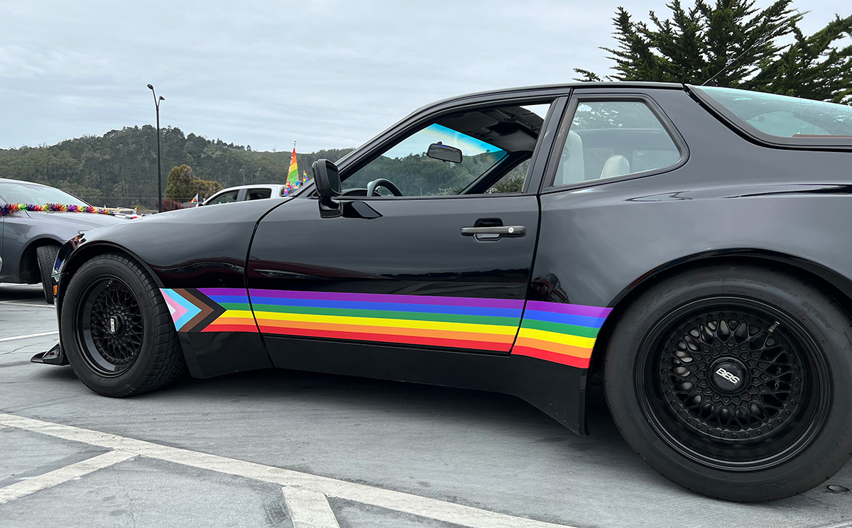 black car with progress-pride colors on the side