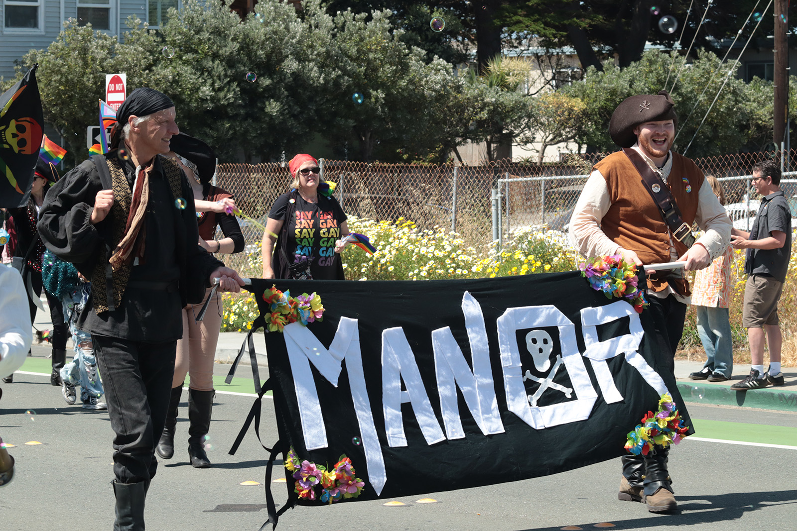 manor pirates carrying their banner in the parade